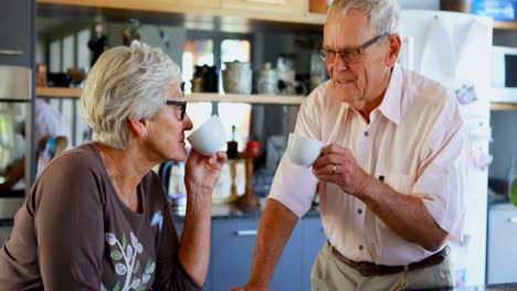 Senior-couple-having-coffee-in-kitchen-4k