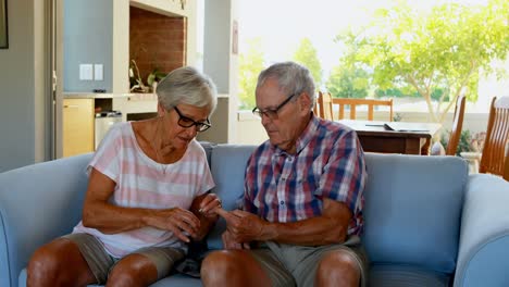 Senior-couple-checking-blood-sugar-on-glucometer-4k