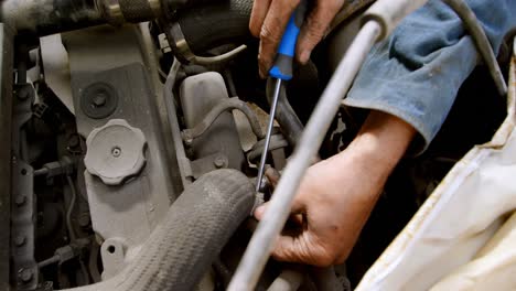 Mechanic-fixing-a-car-at-repair-garage-4k