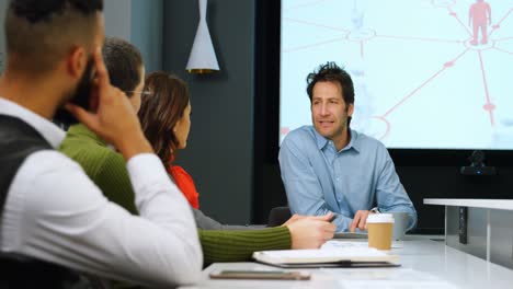 Executives-interacting-with-each-other-in-conference-room-4k