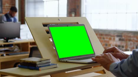 Executive-using-laptop-at-desk-4k