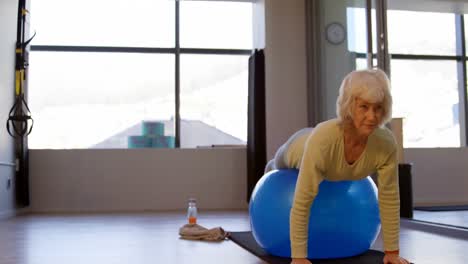 Senior-woman-exercising-on-exercise-ball-4k
