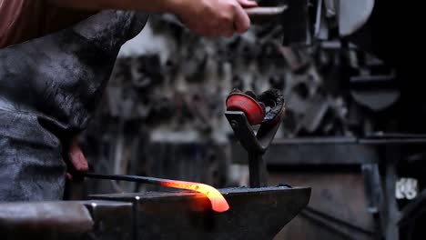 Blacksmith-shaping-the-molten-metal-with-hammer-4k
