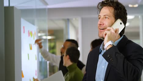 Businessman-talking-on-mobile-phone-in-office-4k