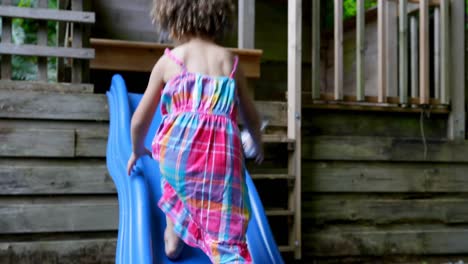 Baby-girl-playing-on-slide-at-backyard-4k