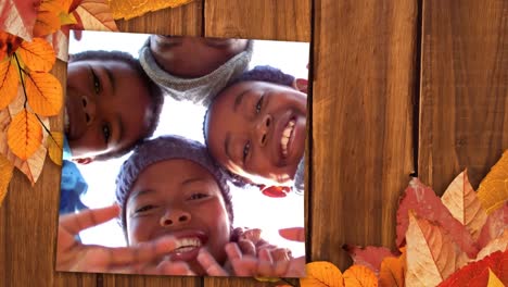Screen-with-autumn-leaves-on-corners-showing-a-happy-family-waving-hands