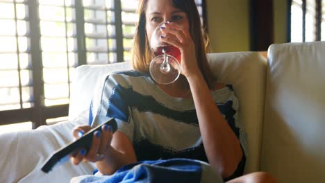 Woman-having-red-wine-while-watching-television-4k