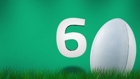 Rugby-ball-on-grass-with-countdown-against-green-background-4k