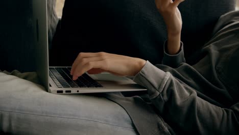 Man-talking-on-mobile-phone-while-using-laptop-at-home-4k