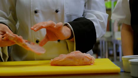 Chef-cutting-meat-on-chopping-board-in-kitchen-4k