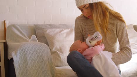 Mother-feeding-her-baby-at-home-4k