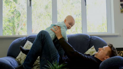Father-playing-with-his-baby-boy-in-living-room-4k