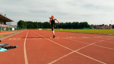 Female-athletic-running-on-sports-track-4k