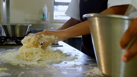 Chef-kneading-dough-in-kitchen-at-restaurant-4k