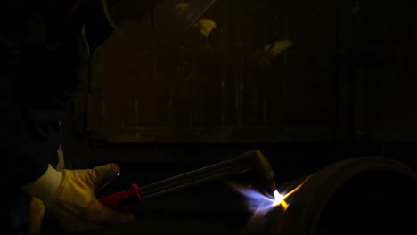 Metalsmith-using-welding-torch-in-workshop-4k