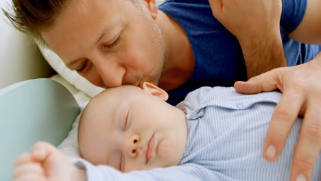 Father-kissing-his-baby-boy-in-bedroom-4k
