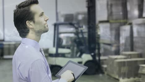 Warehouse-Composition-Man-in-the-warehouse-holding-a-tablet-combined-with-animation-of-co