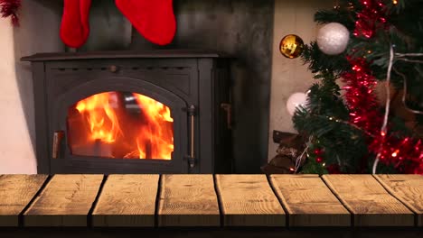 Wooden-foreground-with-Christmas-background-of-tree-and-fire