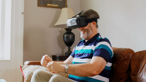 Senior-man-using-virtual-reality-headset-in-living-room-4k