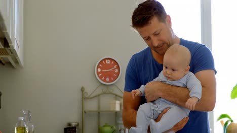 Father-playing-with-his-baby-boy-in-kitchen-4k