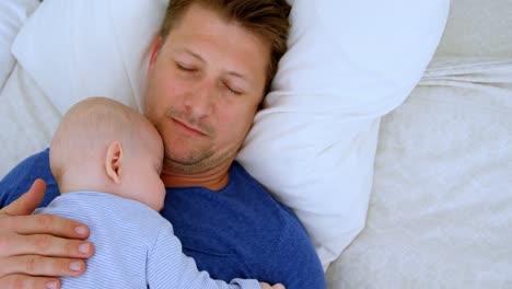 Father-and-baby-boy-sleeping-in-bedroom-4k
