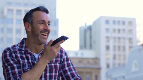 Man-talking-on-mobile-phone-in-balcony-at-home-4k
