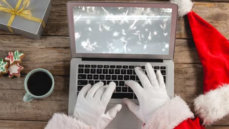 Santa-using-laptop-with-Christmas-snowflakes