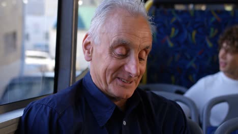 Senior-man-smiling-while-travelling-in-bus-4k