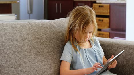 Girl-using-digital-tablet-in-living-room-4k