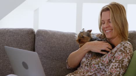Woman-playing-with-her-dog-in-living-room-4k