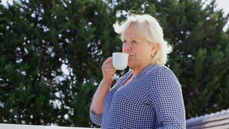 Senior-woman-having-coffee-on-terrace-4k