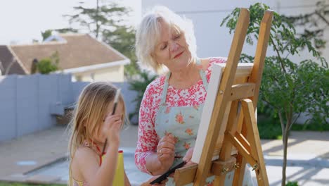Granddaughter-and-grandmother-painting-on-canvas-4k