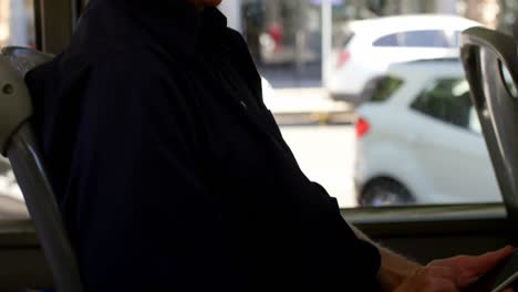 Senior-man-talking-on-mobile-phone-while-travelling-in-bus-4k