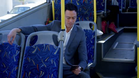 Business-commuter-using-mobile-phone-while-travelling-in-bus-4k