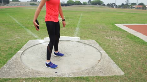Low-section-of-female-athlete-getting-ready-for-discus-throw-at-sports-venue.4k