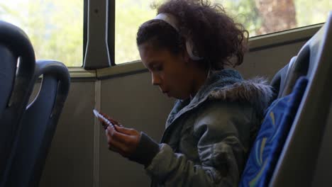 Girl-listening-music-on-headphones-while-travelling-in-bus-4k
