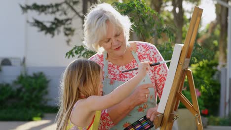 Granddaughter-and-grandmother-painting-on-canvas-4k