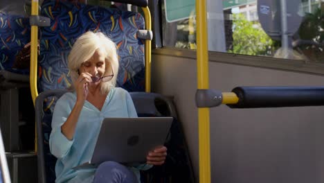 Female-commuter-using-laptop-while-travelling-in-bus-4k