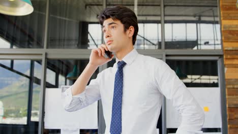 Executive-talking-on-mobile-phone-in-the-office-4k