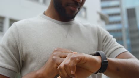 Man-using-smartwatch-in-city-4k