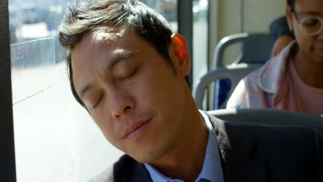 -Male-commuter-sleeping-while-travelling-in-bus-4k