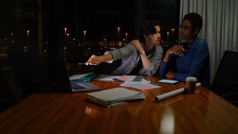 Business-colleagues-discussing-over-documents-4k