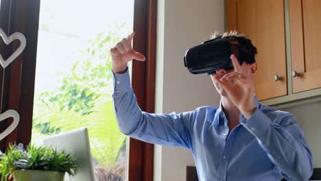 Man-using-virtual-reality-headset-in-kitchen-4k