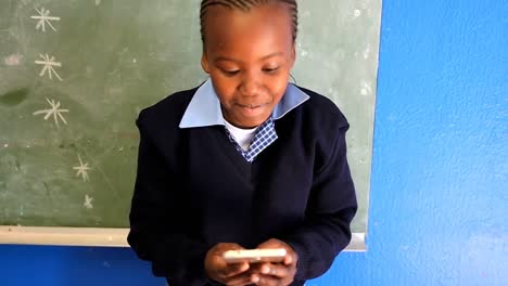 Schoolgirl-using-mobile-phone-in-the-classroom-4k