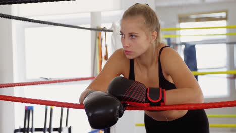 Female-boxer-standing-in-boxing-ring-4k