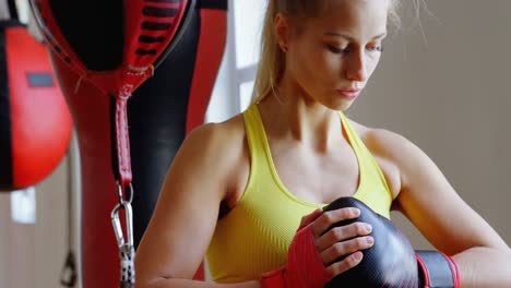 Female-boxer-standing-in-fitness-studio-4k