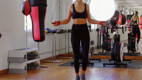 Female-boxer-exercising-with-skipping-rope-4k