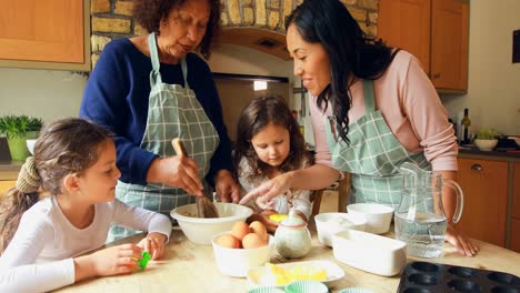 Siblings-preparing-food-with-family-in-kitchen-4k