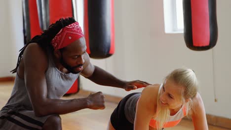 Trainer-training-female-boxer-in-fitness-studio-4k