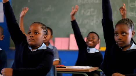 Schoolkids-hands-raised-in-the-classroom-4k